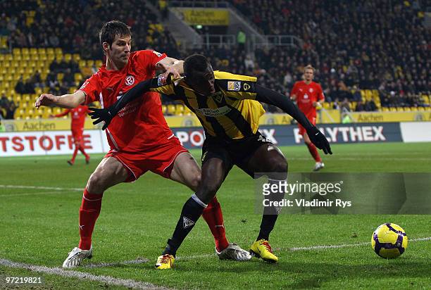 Jens Langeneke of Fortuna defends as Babacar Gueye of Aachen attacks during the Second Bundesliga match between Alemannia Aachen and Fortuna...