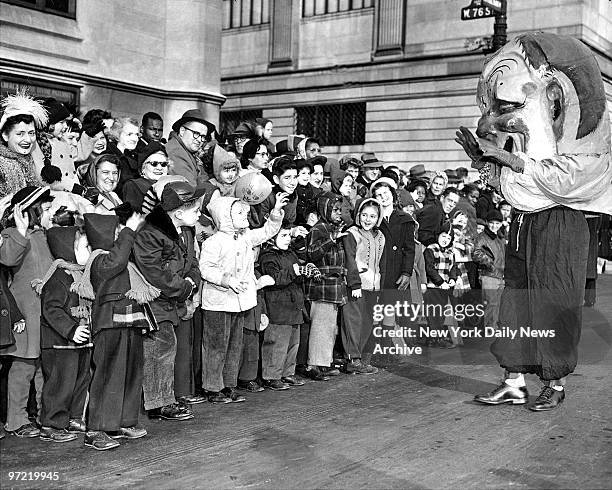 Clown whose "head' is in danger of blowing away becomes big favorite with kiddies jamming street along Central Park West at Macy's Thanksgiving Day...