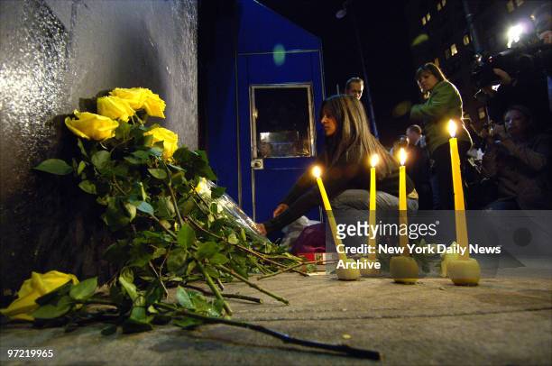 Woman lays flowers at a makeshift memorial for Imette St. Guillen outside The Falls bar on Lafayette St. In Manhattan. The bar was the last place the...
