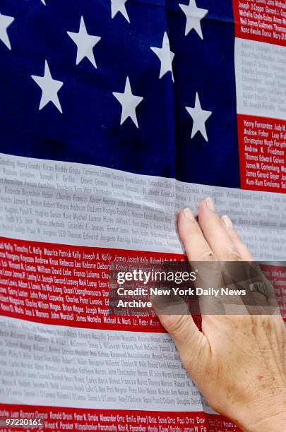 Woman searches the names of 9/11 victims on an American flag, for that of a friend's son, near Ground Zero the day before the sixth anniversary of...