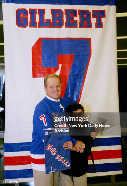 Fan gets a smiling embrace from New York Rangers' Hall-of-Famer Rod Gilbert during Rangers Summer Fan Fest at Madison Square Garden.