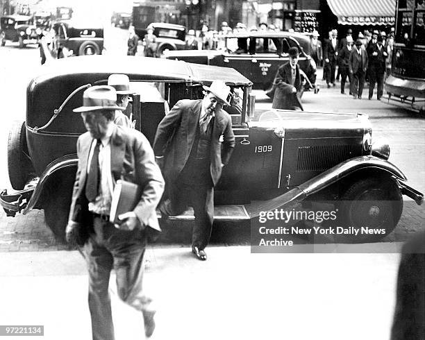 Al Capone leaving a taxi outside the Chicago Federal Courthouse to attend his trial.