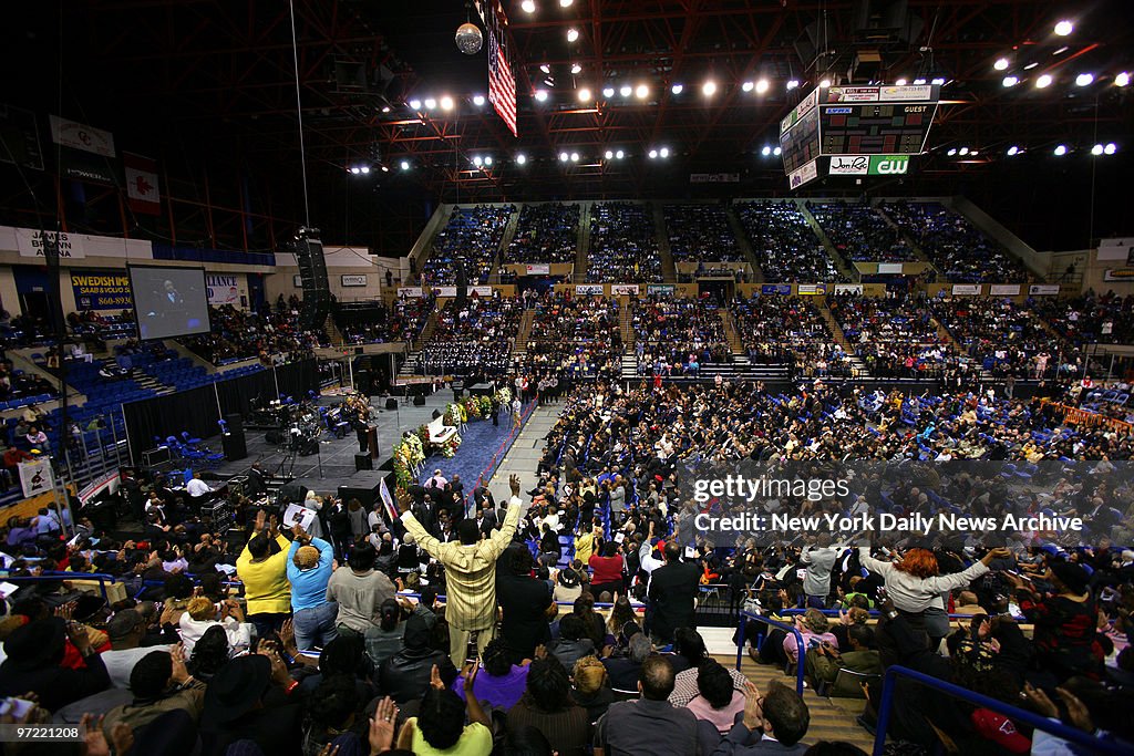 About 9,000 mourners cheer and applaud wildly as the Rev. Al