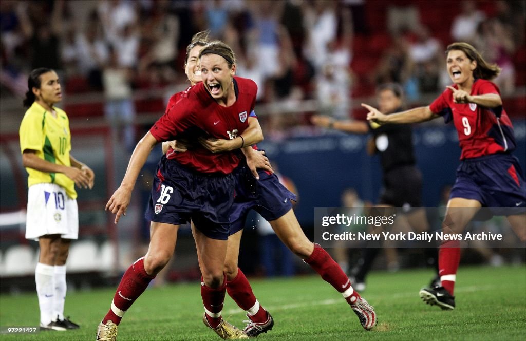 Abby Wambach of the U.S. is hugged by a teammate after scori