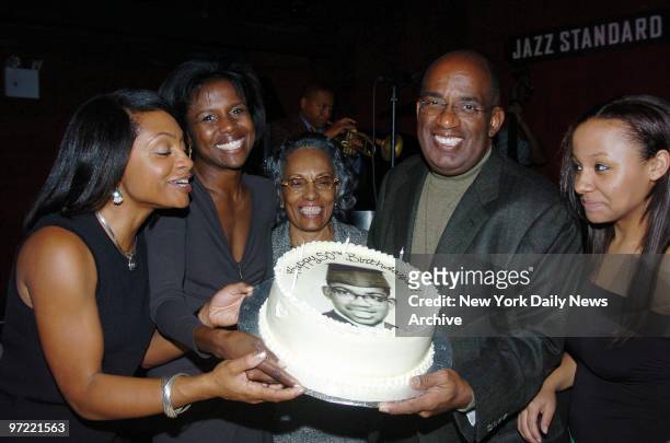 Al Roker takes the cake from his sister, Alison, as his wife, Deborah, his mother, and daughter Courtney watch at his 50th birthday party at Blue...