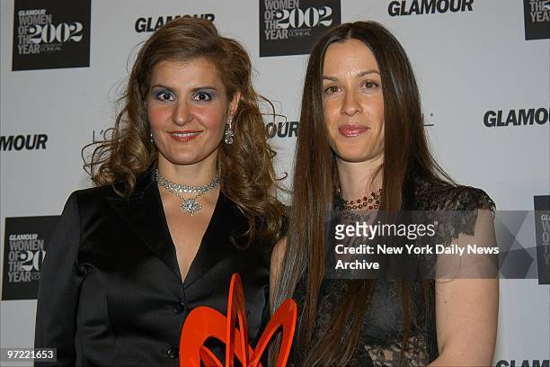Alanis Morissette is joined by Nia Vardalos, who presented her with the award she holds, at Glamour Magazine's annual Women of the Year awards at the...