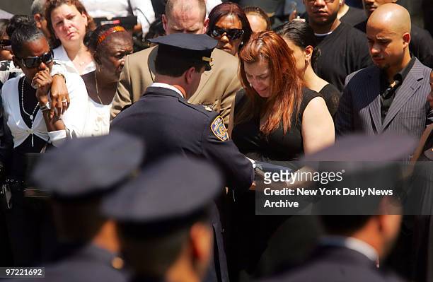 Flag is presented to Wendy Ramirez, wife of Police Officer Alexander Felix, during funeral at Our Lady of Lourdes Church at 463 west 142nd Street....