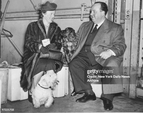 Alfred Hitchcock with his wife, Alma, and their dogs. Hitchcock's movie "The Lady Vanishes" won the Academy Award.