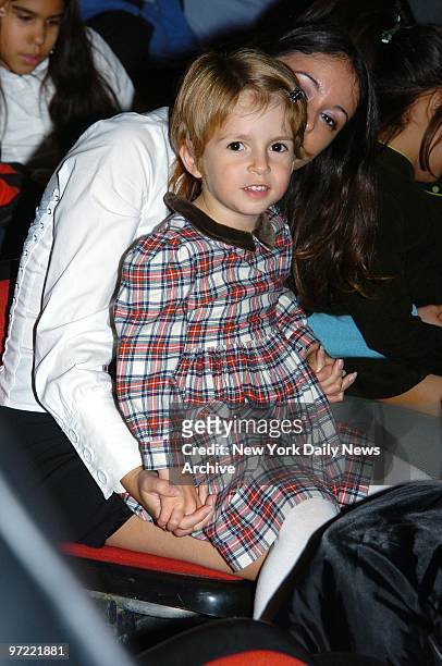 Friend holds Manzie Tio, the daughter of Woody and Soon-Yi Allen, at the Big Apple Circus' opening night gala benefit in Lincoln Center's Damrosch...