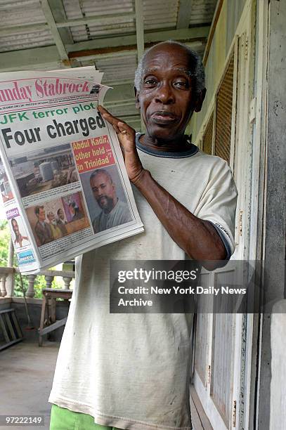 Guyanese man in Linden, Guyana, holds a local newspaper detailing the terror plot to blow up John F. Kennedy International Airport by attacking fuel...