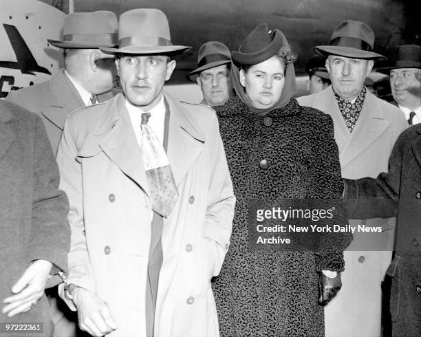 Gloomy looking couple, Raymond Fernandez and his 200-pound mistress, Mrs. Martha Beck leave LaGuardia Field after flight from Michigan. The couple,...