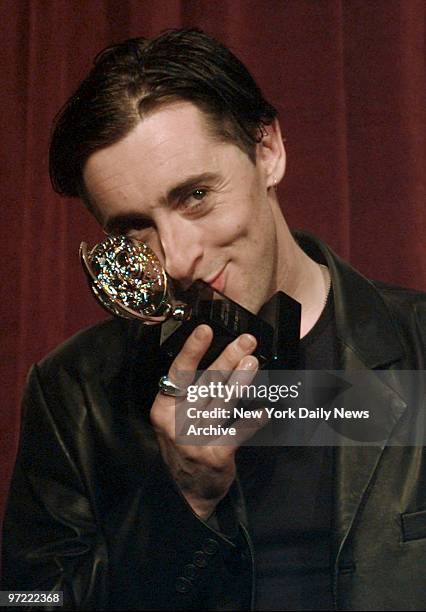 Actor Alan Cumming, winner Best Leading Actor in a Musical for "Cabaret," kissing Tony Awards.