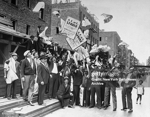Group of workers, mostly electricians and bricklayers, tear up their banners and toss them into the air, as they learn the United States has...