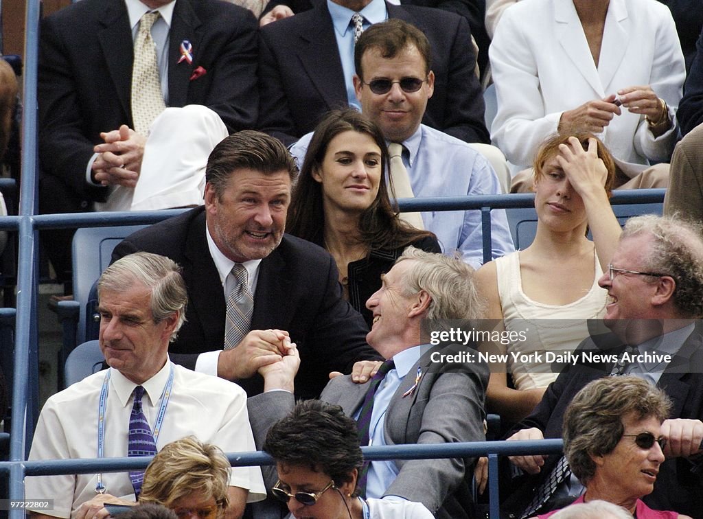Alec Baldwin (left) clasps hands with a fan as Rick Moranis