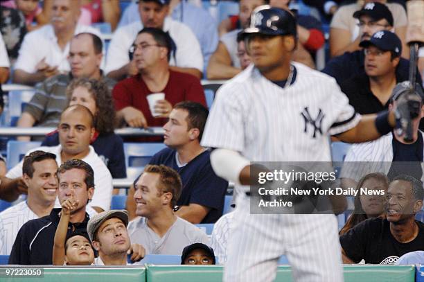 Actor Brad Pitt and son Maddox are in the seats at Yankee Stadium as New York Yankees' Bobby Abreu is on deck during a game between the Yanks and...