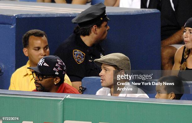 Actor Brad Pitt, Angelina Jolie's son Maddox, right, and director Spike Lee, left, at a New York Yankees-Seattle Mariners game at Yankee Stadium.,