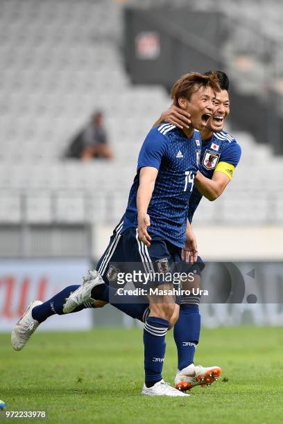 Takashi Inui of Japan celebrates scoring his side's first goal with his team mate Hotaru Yamaguchi during the international friendly match between...