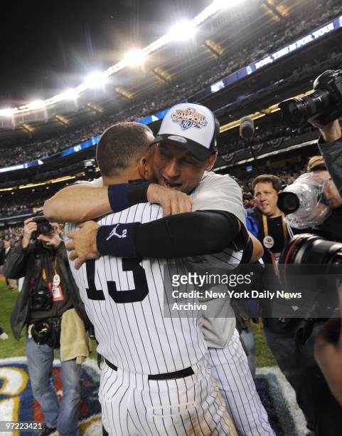 Alex Rodriguez and Yankee captain Derek Jeter hug it out durng wild postgame celebration at Yankee Stadium last night after cinching Bombers' 27th...