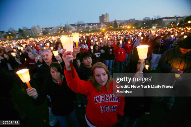 Large group of people gather on the grounds of Virginia Tech for a candlelight vigil the day after gunman Cho Seung-Hui a student at the university,...
