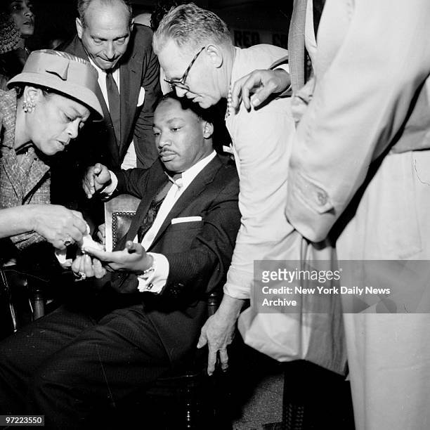 Letter opener protruding from his chest, the Rev. Martin Luther King has would treated at W. 123rd St. Police station. The leader of a bus boycott by...