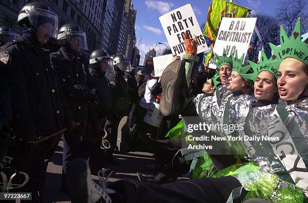 Lineup of police officers faces a row of high-kicking World Economic Forum protesters during a rally at Columbus Circle on Central Park West. The...