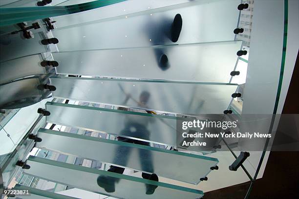 Maintenance man at the Apple Store on Fifth Ave. In midtown tries to keep the glass staircase clean and dry from the slush and water tracked in from...