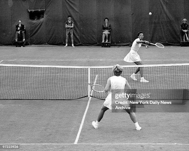 Althea Gibson waits intently under a return by Darlene Hard during the first set of their match at Fores Hills. The Wimbledon champ missed the shot...