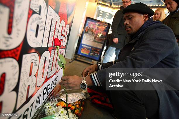 Man places a rose at a makeshift memorial for soul singer James Brown outside B.B. King's Blues Club on W. 42nd St. The "Godfather of Soul" died of...