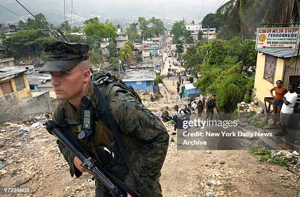 Marine from the Lima Company, 3rd Battalion, 8th Marines patrols a hilly road in Port-au-Prince, Haiti. The regiment, which is based in Camp Lejeune,...