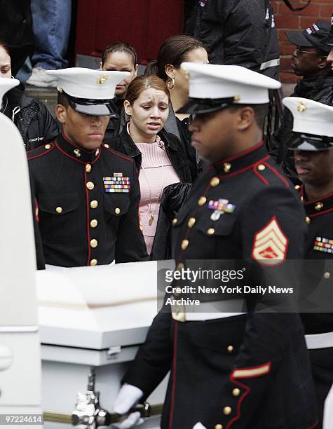 Marine honor guard carries the casket of Nixzmary Brown past mourners to a waiting hearse outside St. Mary's Church on Grand St. After her funeral...
