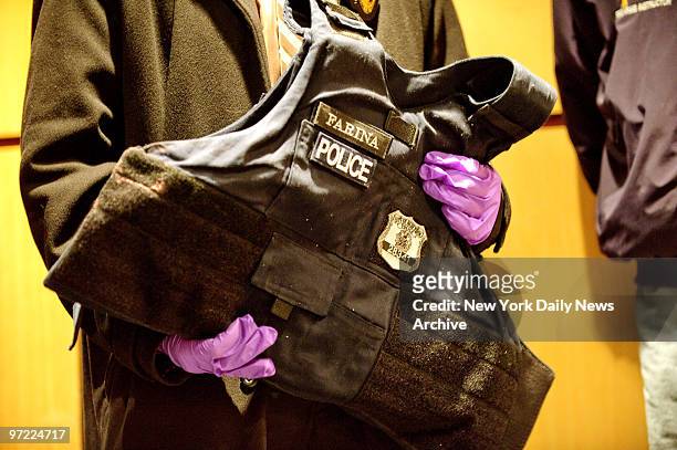 Member of the NYPD holds the protective vest belonging to one of the officers shot. Mayor Michael Bloomberg and NYPD Police Commissioner Ray Kelly at...