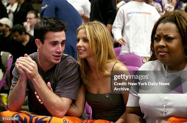 Actor Freddie Prinze Jr. And actress Sarah Michelle Geller take in the action as the New York Knicks chilled the Miami Heat, 91-83, in Game 4 of the...