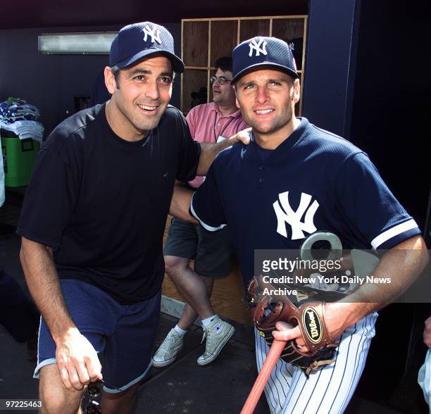 Actor George Clooney takes on the role of baseball fan as he gets together with New York Yankees' second baseman Chuck Knoblauch during a visit to...