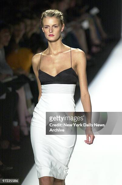 Model wears a white dress with contoured black bra top during the showing of Narciso Rodriguez' new collection as part of Spring Fashion Week 2003.