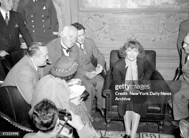 New Greta Garbo arrives on the liner Gripsholm, smilingly willing to pose for newspapper photographers and chat with interviewers.