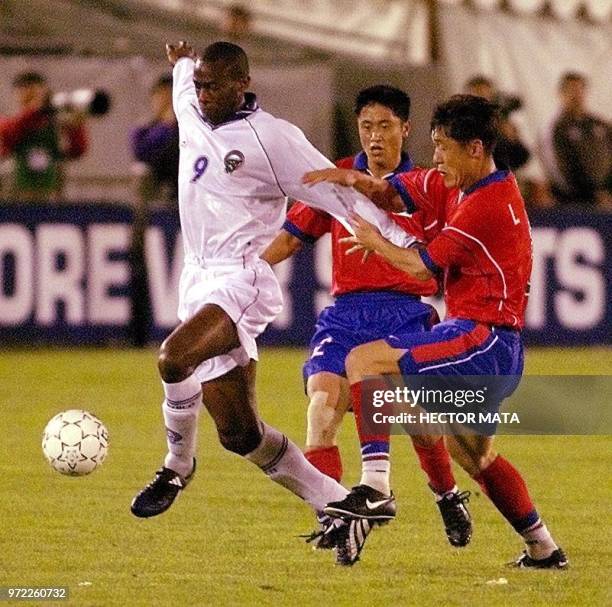 South Korean player Lee Lim Saeng and Costa Rican player Paulo Wanchope fight for the ball during first half action of the CONCACAF Gold Cup at the...