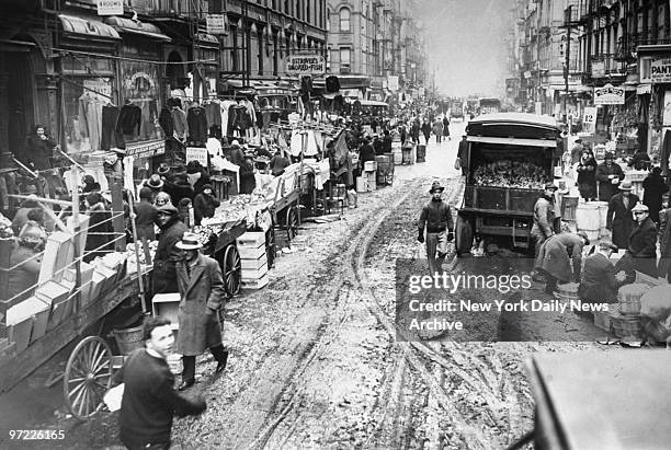Always crowded on Sunday, the picturesque market place of the lower East Side is trodden into slush on Orchard St. Near Delancey St. The long block...