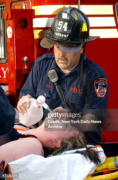 Paramedic tries to revive a woman in cardiac arrest who was pulled out of a buildling on W. 65th St. On Tuesday morning. The woman was later revived...