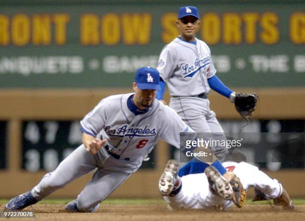 Los Angeles Dodgers' second baseman Mark Grudzielanek tags out Milwaukee Brewers' outfielder Alex Sanchez on a steal attempt as Dodgers' shortstop...