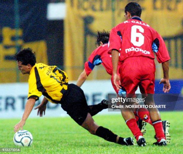 Juan Carlos Parra player of the Guarani falls because of Juan Carlos Burbano and Jorge Guagua of the Nacional during a match for the Group 5 of the...