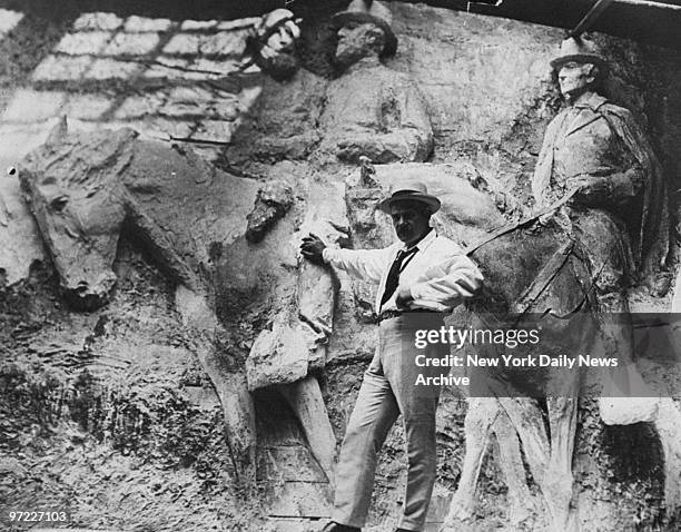 American sculptor Gutzon Borglum is shown in his studio with models of Confederate generals, which will be carved on Stone Mountain near Atlanta, GA.