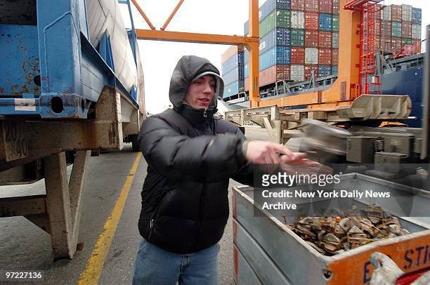 American Stevedoring longshoreman Rocco Cinardi removes shoes from a container at company's operations on Piers 9-11 in Red Hook, Brooklyn. The Port...