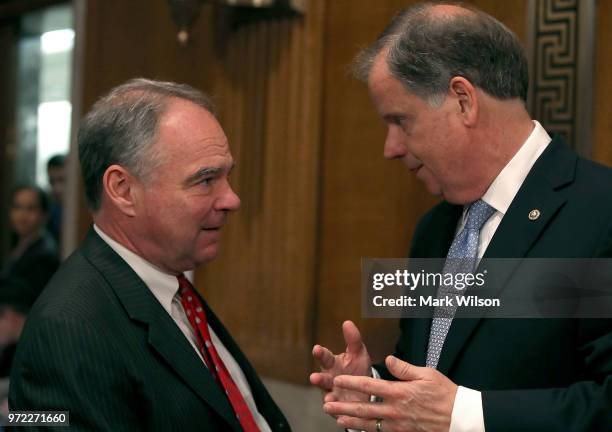 Sen. Tim Kaine , , talks with Sen. Doug Jones , during a Senate Health, Education, Labor and Pensions Committee hearing, on Capitol Hill June 12,...