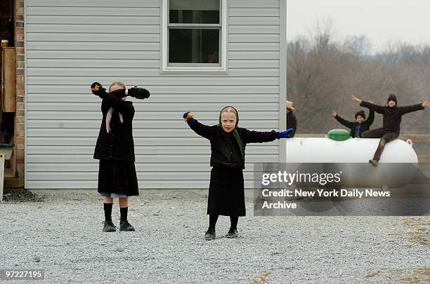 Amish children play in a schoolyard next to the new one room school house just built off Mine Rd. The school house is within a couple hundred yards...