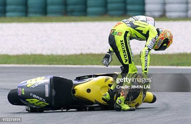 Valentino Rossi of Italy picks himself up after falling off his bike and out of the 500cc race at the Malaysian Motorcycle Grand Prix at the Sepang...