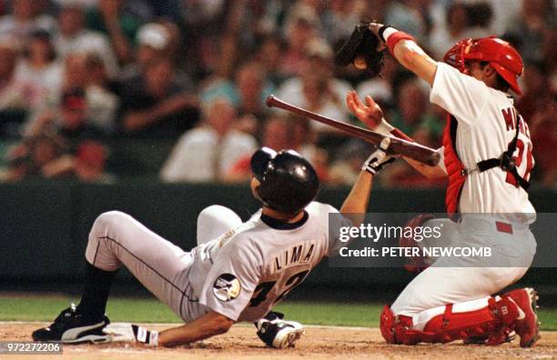 Houston Astro pitcher Jose Lima falls down as he avoids the pitch by St. Louis Cardinal pitcher Manny Abar in St. Louis, MO 22 June 1999 and Cardinal...