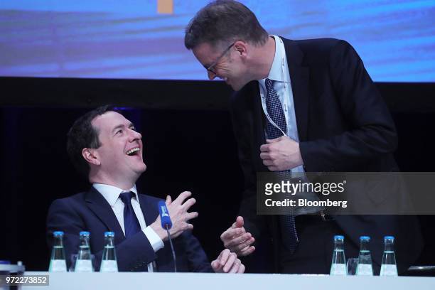 George Osborne, editor of the Evening Standard newspaper, left, and Christian Sewing, chief executive officer of Deutsche Bank AG, react during the...