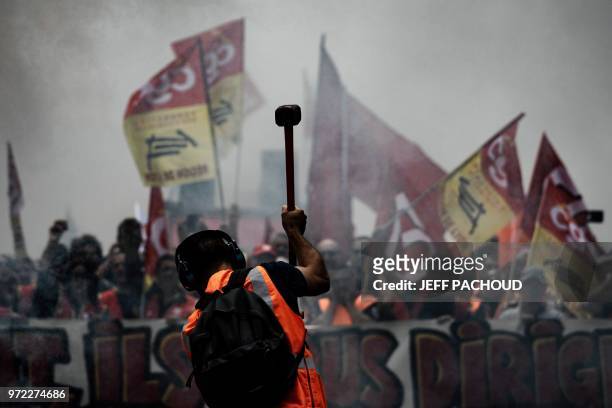 French railway workers demonstrate on June 12, 2018 on the streets of the city of Lyon on the 15th day of rolling train strikes which began in April...