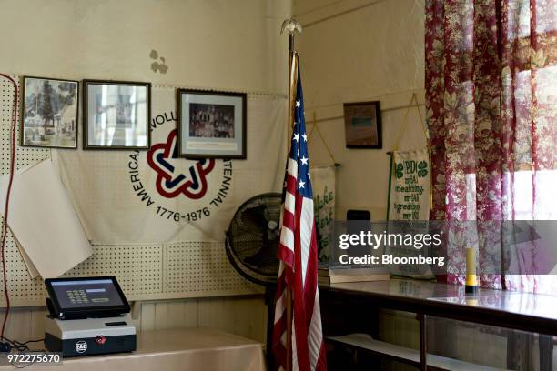 An American flag stands at a polling location during the primary election in Lebanon Church, Virginia, U.S., on Tuesday, June 12, 2018. In the...