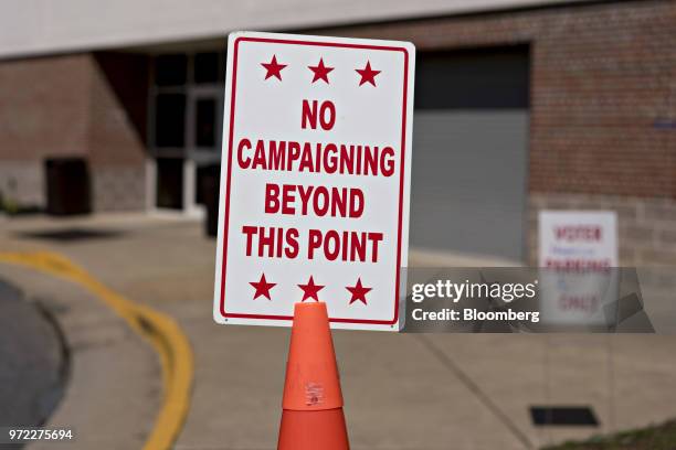 No Campaigning" sign stands outside a polling location during the primary election in Strasburg, Virginia, U.S., on Tuesday, June 12, 2018. In the...